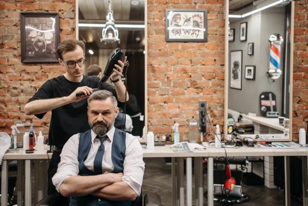 Man getting hair styled at a barbershop