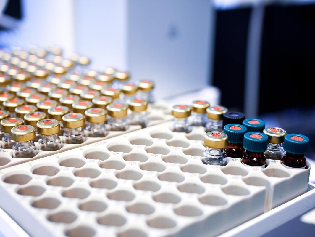 Small sealed laboratory sample vials arranged in a testing tray.